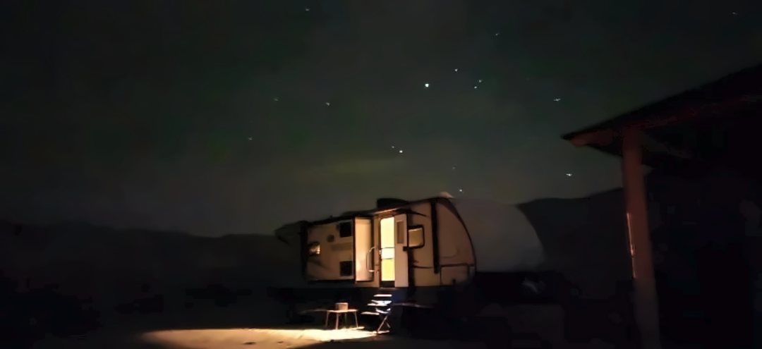Our travel trailer lit up under the stars at Rainbow Basin in the Mojave Desert